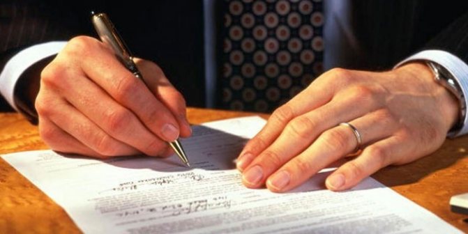 Man signing papers